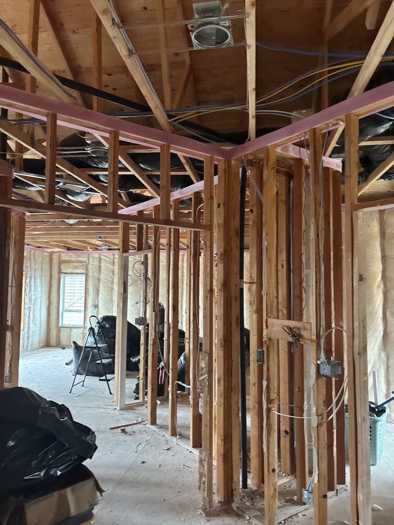 Wide interior view of open-frame plumbing work area for repipe planning