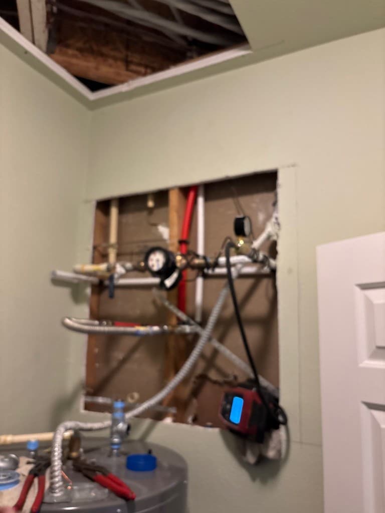 Mechanical area before final wall closure with active repipe connections visible