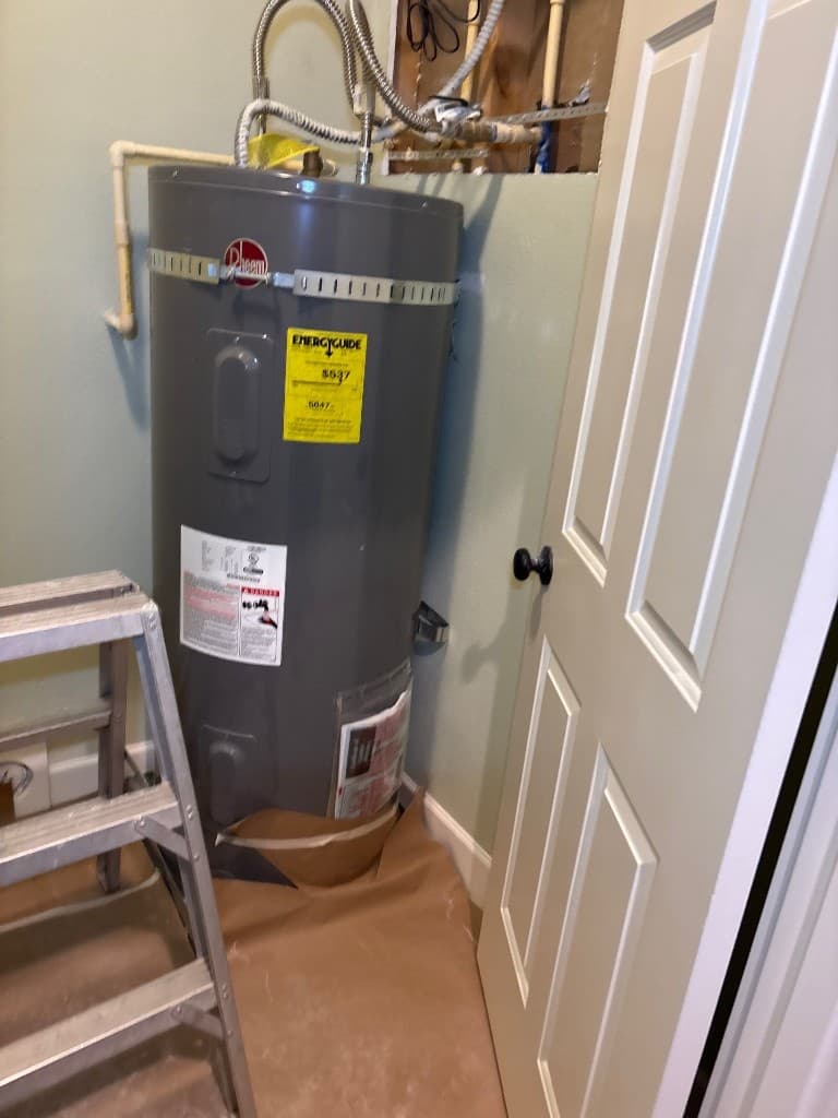 Water heater area after installation with updated lines following repipe work