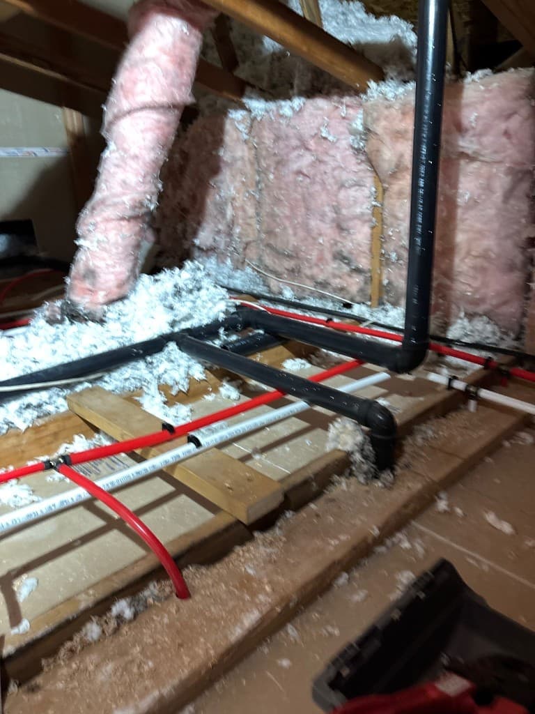 Attic-level PEX and drain routing with insulation around active repipe lines