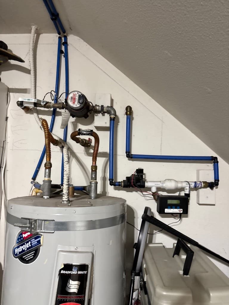 Upgraded water heater and meter-side line routing after repipe improvements